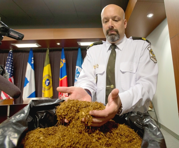 Sureté du Québec Lt. Guy Lapointe shows tobacco seized by the Quebec police force at a news conference, April 30, 2014 in Montreal. Photo credit: Ryan Remiorz , THE CANADIAN PRESS.
